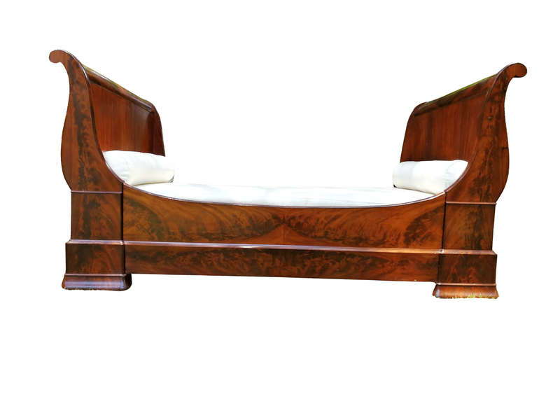 A French Flame Mahogany Lit-En-Bateau / Daybed on Wooden Castors. Circa 1950