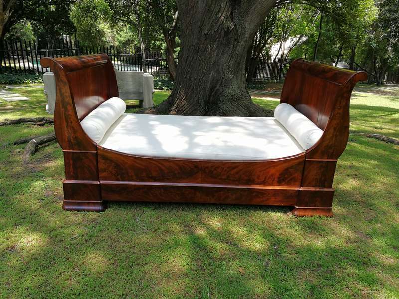 A French Flame Mahogany Lit-En-Bateau / Daybed on Wooden Castors. Circa 1950