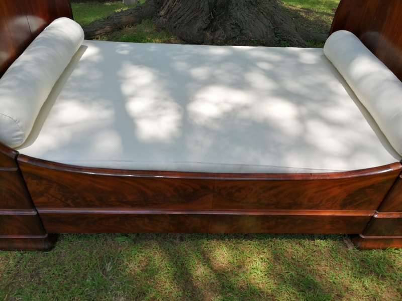 A French Flame Mahogany Lit-En-Bateau / Daybed on Wooden Castors. Circa 1950
