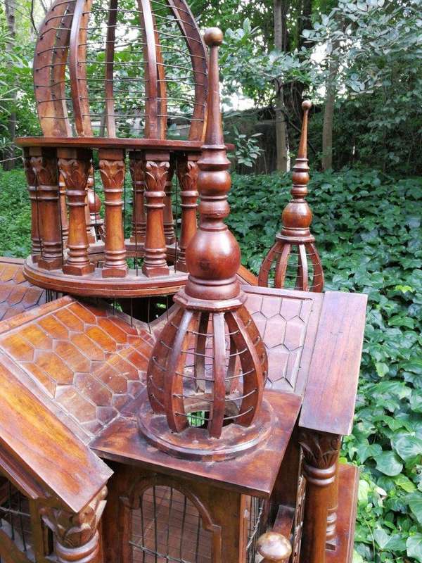 A 20th Century French Carved Mahogany and Walnut Victorian Cathedral Style Birdcage on Stand