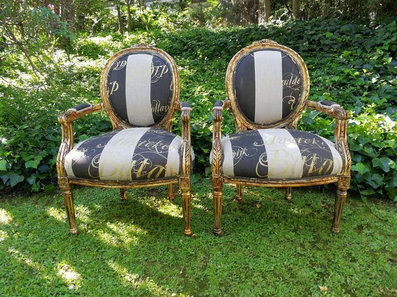 A Pair of French Style Arm Chairs Hand Gilded With Gold Leaf And Upholstered In an Imported Scrip...