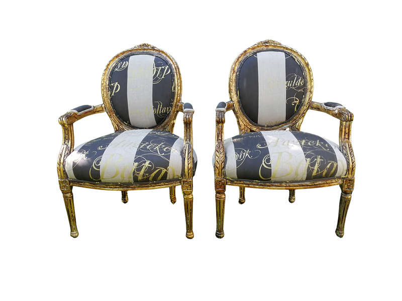 A Pair of French Style Arm Chairs Hand Gilded With Gold Leaf And Upholstered In an Imported Scrip...