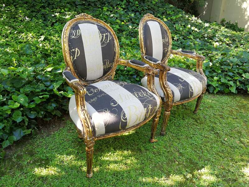 A Pair of French Style Arm Chairs Hand Gilded With Gold Leaf And Upholstered In an Imported Scrip...