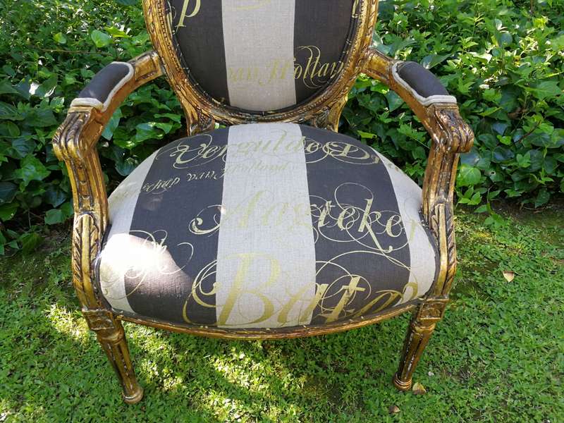 A Pair of French Style Arm Chairs Hand Gilded With Gold Leaf And Upholstered In an Imported Scrip...