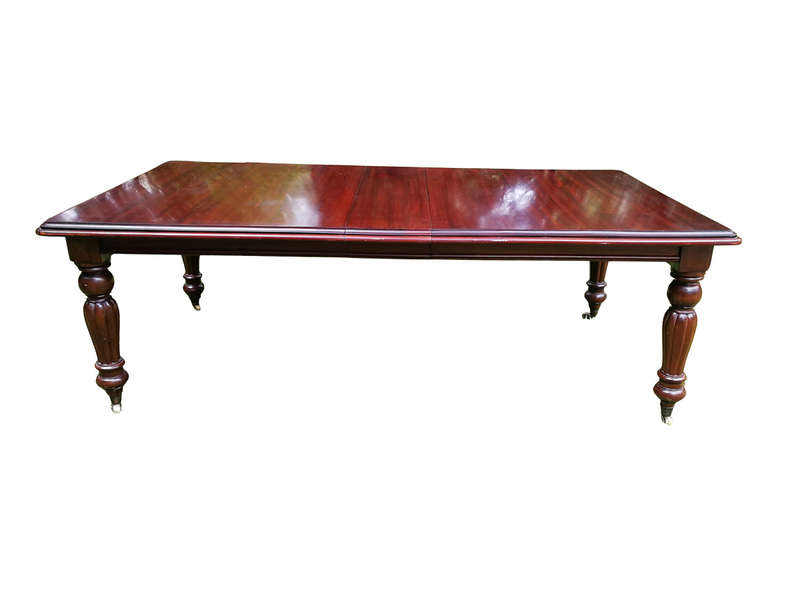 A Victorian Style Mahogany extending ten-seater dining room table on brass castors and with windi...
