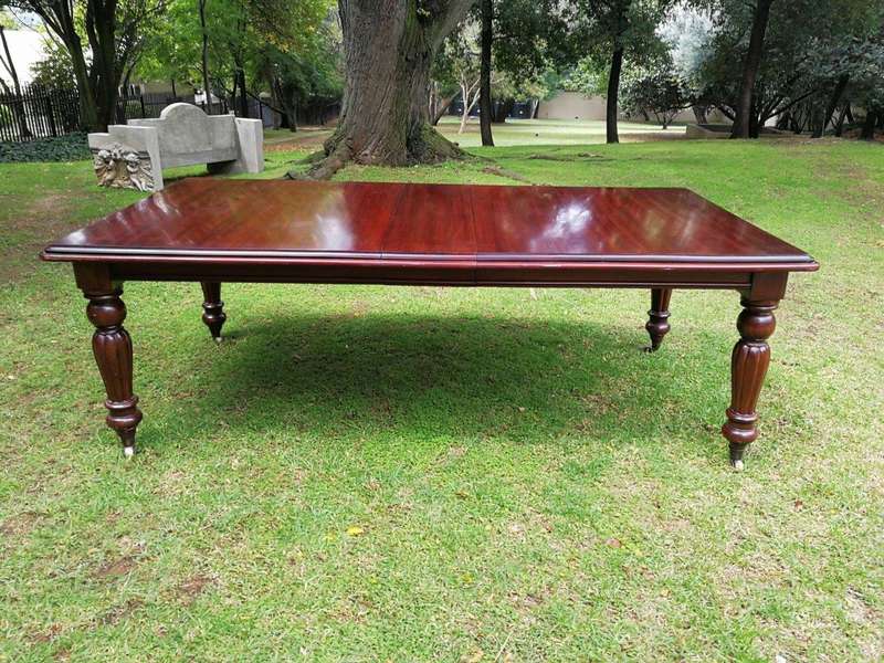 A Victorian Style Mahogany extending ten-seater dining room table on brass castors and with windi...