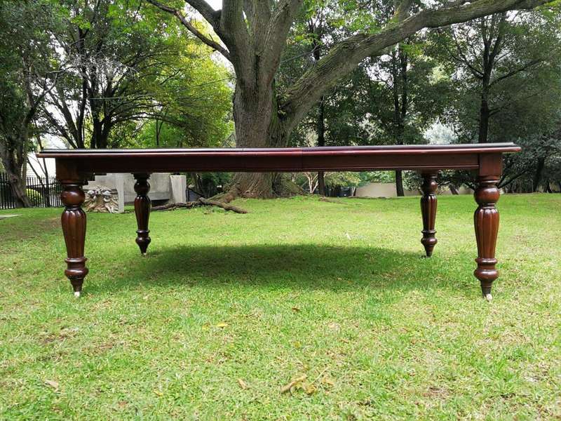 A Victorian Style Mahogany extending ten-seater dining room table on brass castors and with windi...