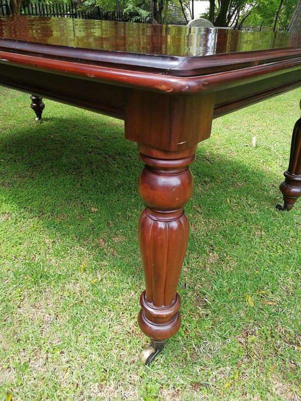 A Victorian Style Mahogany extending ten-seater dining room table on brass castors and with windi...