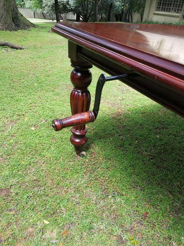 A Victorian Style Mahogany extending ten-seater dining room table on brass castors and with windi...
