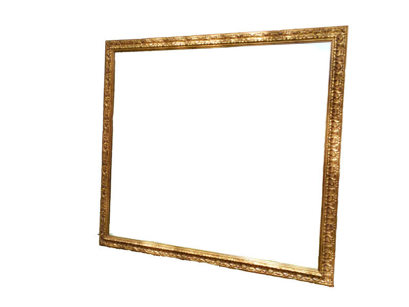A large gilded mirror with ornate frame