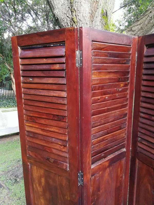 A 20th century Mahogany three-panel folding floor screen, with adjustable louvered panels