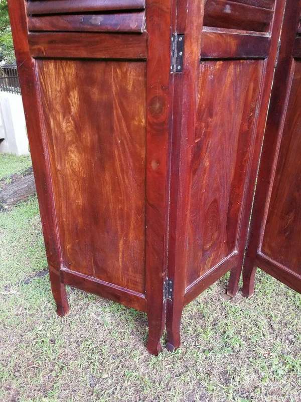A 20th century Mahogany three-panel folding floor screen, with adjustable louvered panels