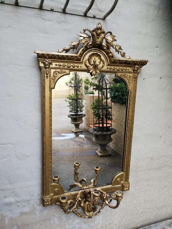 A gilded girandole mirror