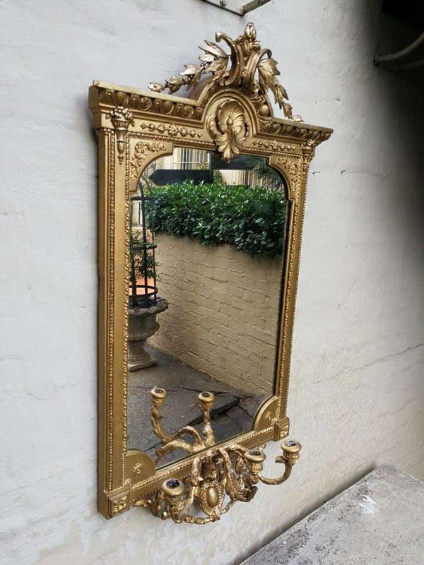 A gilded girandole mirror