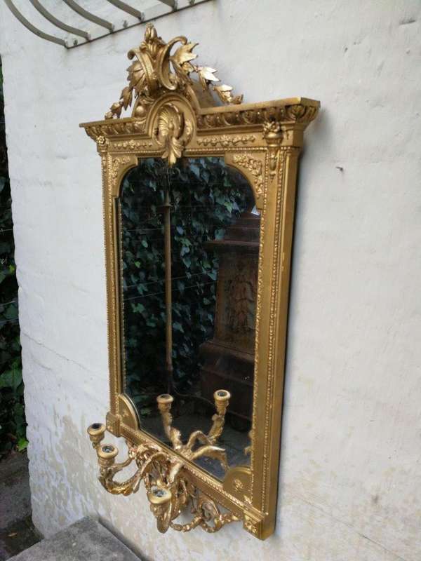 A gilded girandole mirror