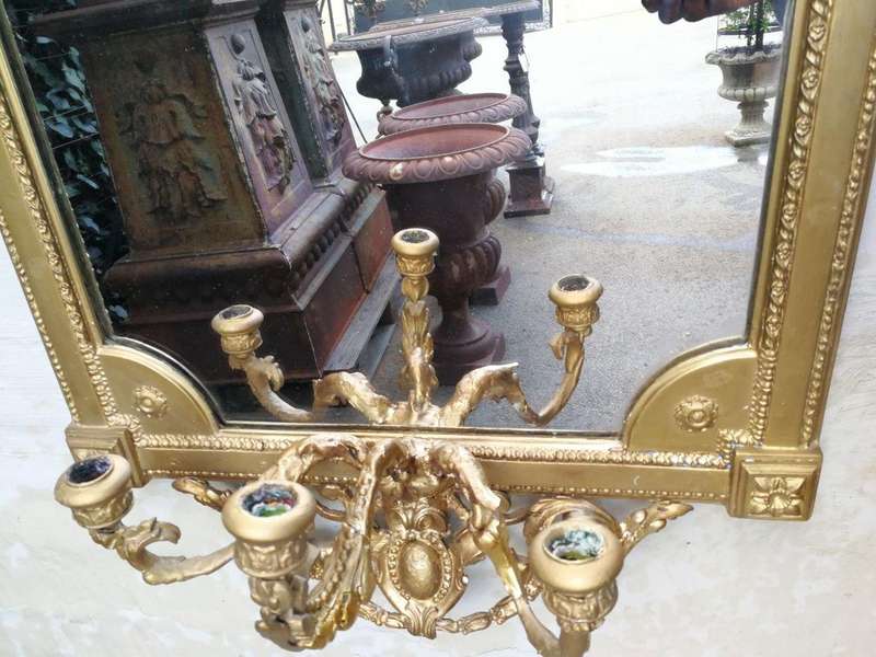 A gilded girandole mirror