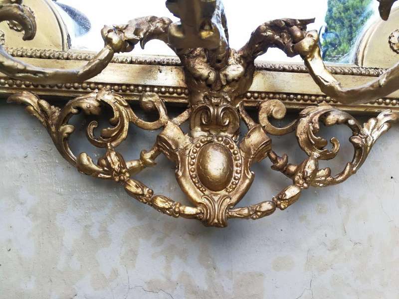 A gilded girandole mirror