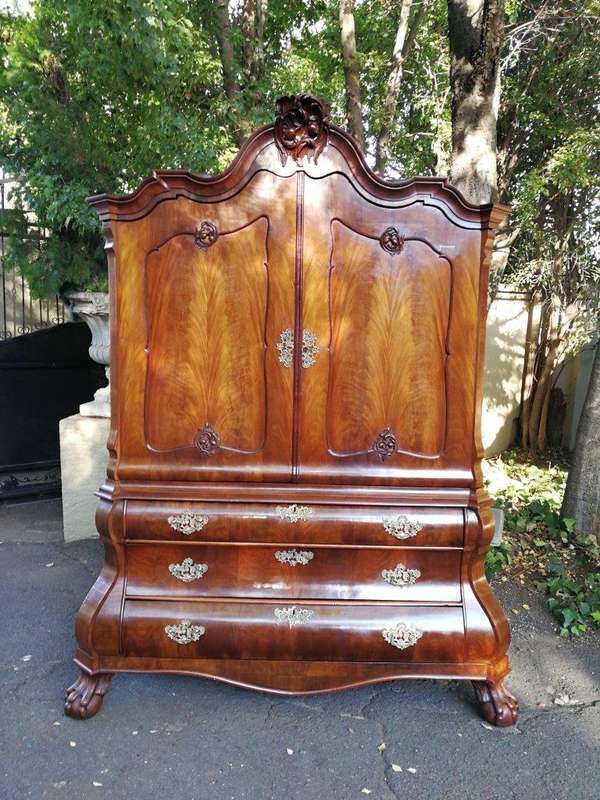 An 18th century (circa 1770) Dutch mahogany cabinet on bombe base/armoire with the original brass...
