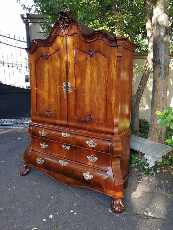 An 18th century (circa 1770) Dutch mahogany cabinet on bombe base/armoire with the original brass...