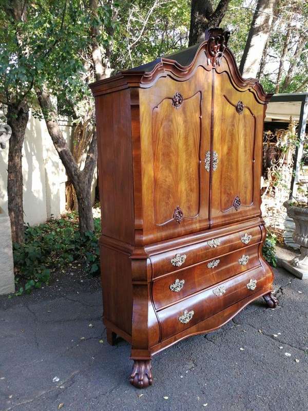 An 18th century (circa 1770) Dutch mahogany cabinet on bombe base/armoire with the original brass...