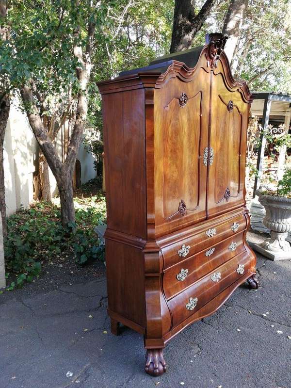 An 18th century (circa 1770) Dutch mahogany cabinet on bombe base/armoire with the original brass...