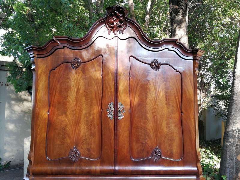 An 18th century (circa 1770) Dutch mahogany cabinet on bombe base/armoire with the original brass...