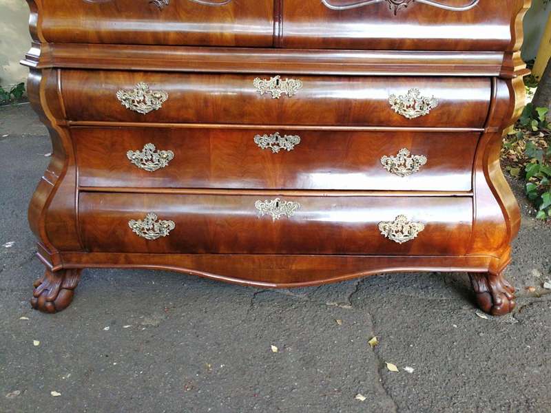 An 18th century (circa 1770) Dutch mahogany cabinet on bombe base/armoire with the original brass...