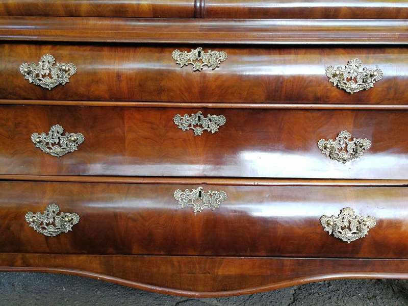 An 18th century (circa 1770) Dutch mahogany cabinet on bombe base/armoire with the original brass...