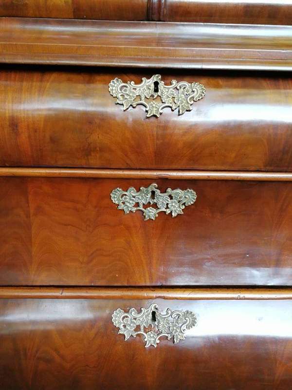 An 18th century (circa 1770) Dutch mahogany cabinet on bombe base/armoire with the original brass...