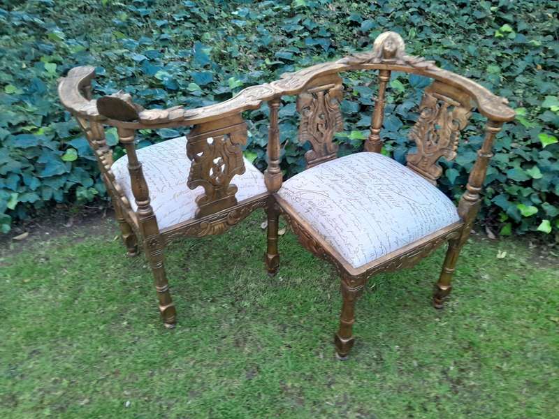An Antique French-Style Carved Conversation Settee Hand-Gilded and Upholstered in a Custom-made S...