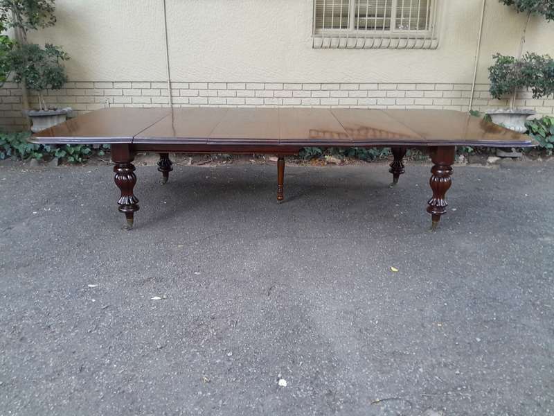 A Massive and Rare Victorian Mahogany Dining / Boardroom Extension table with Four Extensions and...