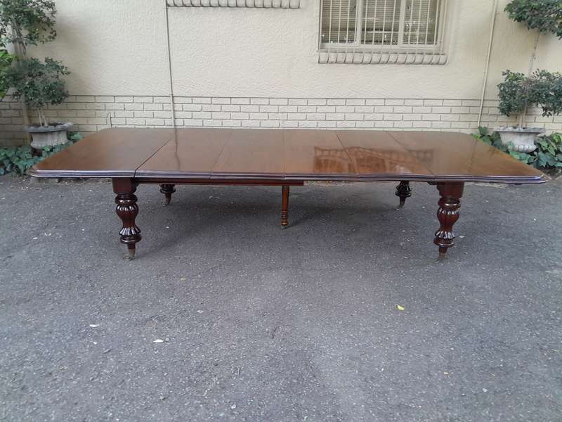 A Massive and Rare Victorian Mahogany Dining / Boardroom Extension table with Four Extensions and...