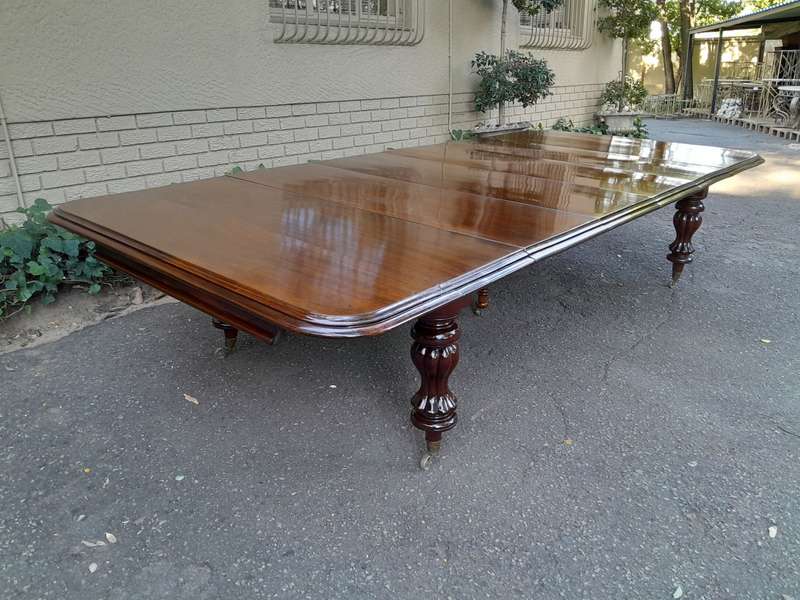 A Massive and Rare Victorian Mahogany Dining / Boardroom Extension table with Four Extensions and...