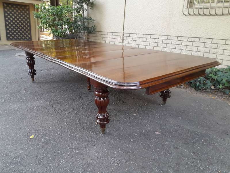 A Massive and Rare Victorian Mahogany Dining / Boardroom Extension table with Four Extensions and...