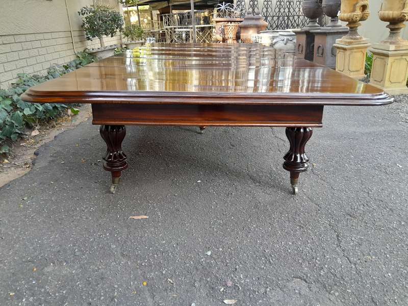 A Massive and Rare Victorian Mahogany Dining / Boardroom Extension table with Four Extensions and...