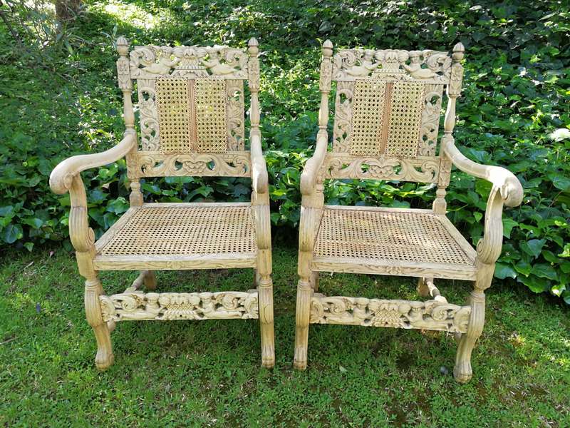 A Pair Or Ornately Carved And Bleached / Natural Wood Finish With Redone Rattan Arm Chairs