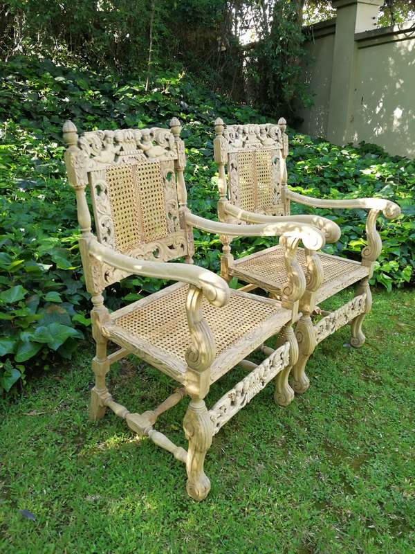 A Pair Or Ornately Carved And Bleached / Natural Wood Finish With Redone Rattan Arm Chairs