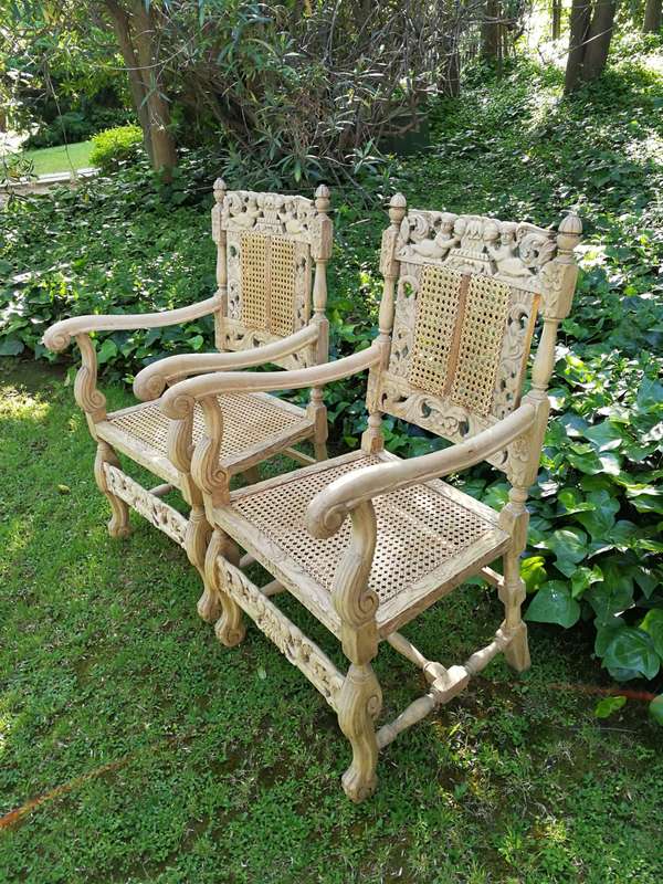 A Pair Or Ornately Carved And Bleached / Natural Wood Finish With Redone Rattan Arm Chairs