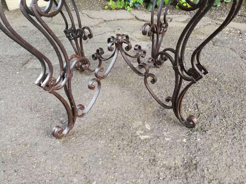 An imported wrought iron table with marble top