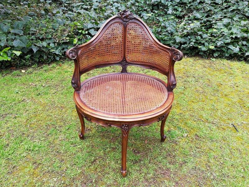 A French Walnut Carved And Rattan Chair