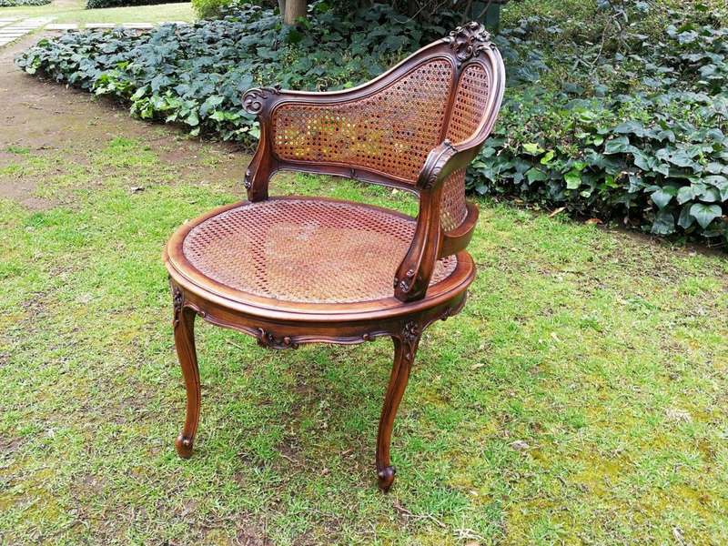 A French Walnut Carved And Rattan Chair