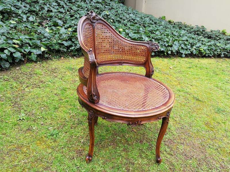 A French Walnut Carved And Rattan Chair