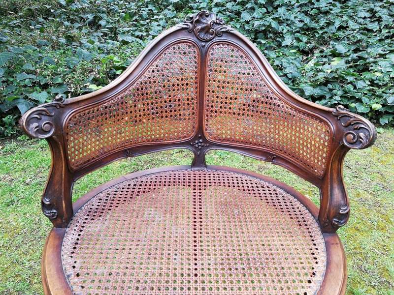 A French Walnut Carved And Rattan Chair