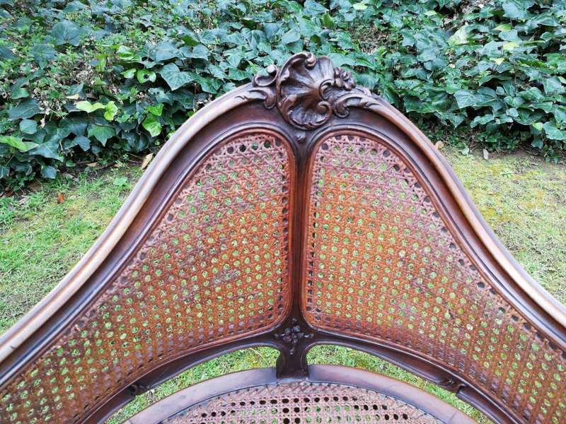 A French Walnut Carved And Rattan Chair