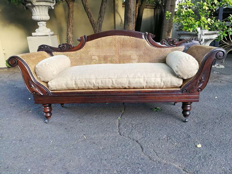 An Antique Victorian Carved Mahogany and Rattan Settee On Castors with Hessian Cushions and Bolsters