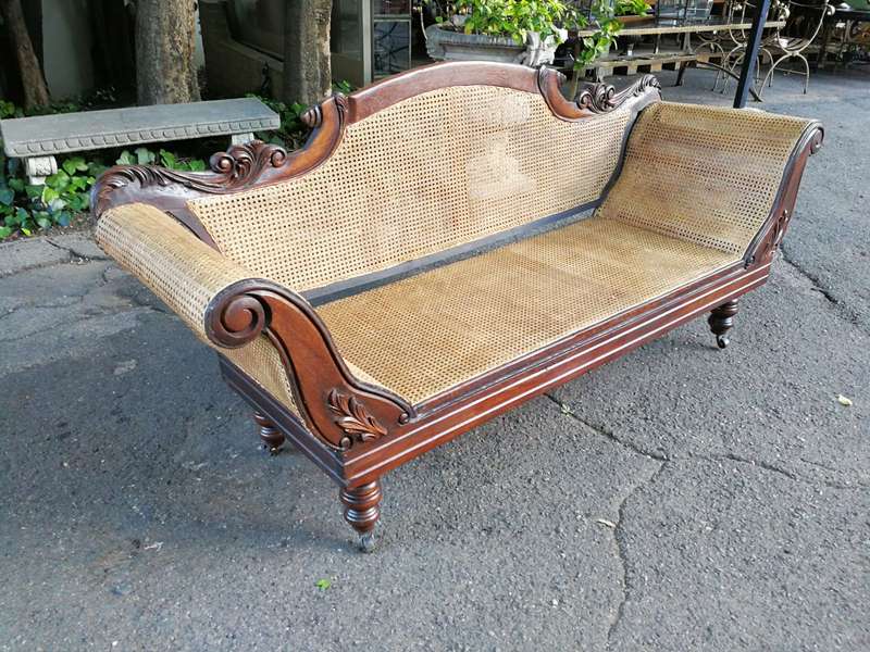 An Antique Victorian Carved Mahogany and Rattan Settee On Castors with Hessian Cushions and Bolsters