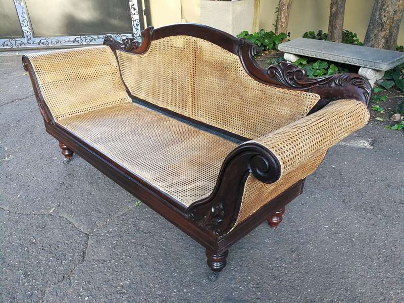 An Antique Victorian Carved Mahogany and Rattan Settee On Castors with Hessian Cushions and Bolsters