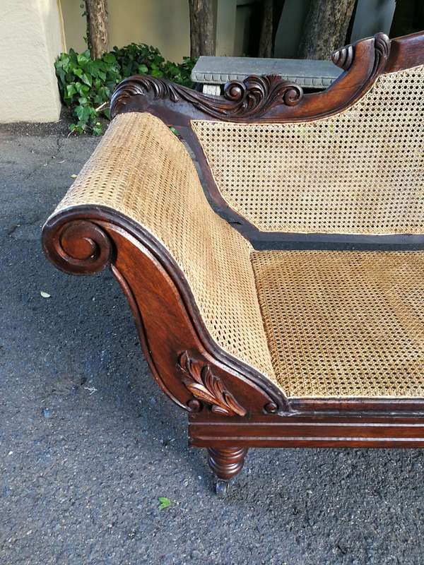 An Antique Victorian Carved Mahogany and Rattan Settee On Castors with Hessian Cushions and Bolsters