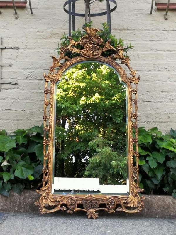 An Ornately Carved and Giltwood Mirror ND