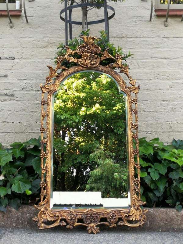 An Ornately Carved and Giltwood Mirror ND